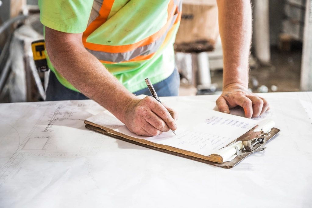 Supervisor de obra revisando planos y anotaciones